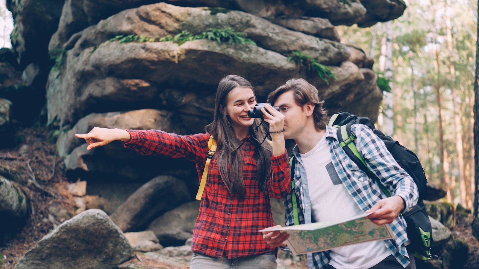 Couple checking a map together on a forest hike