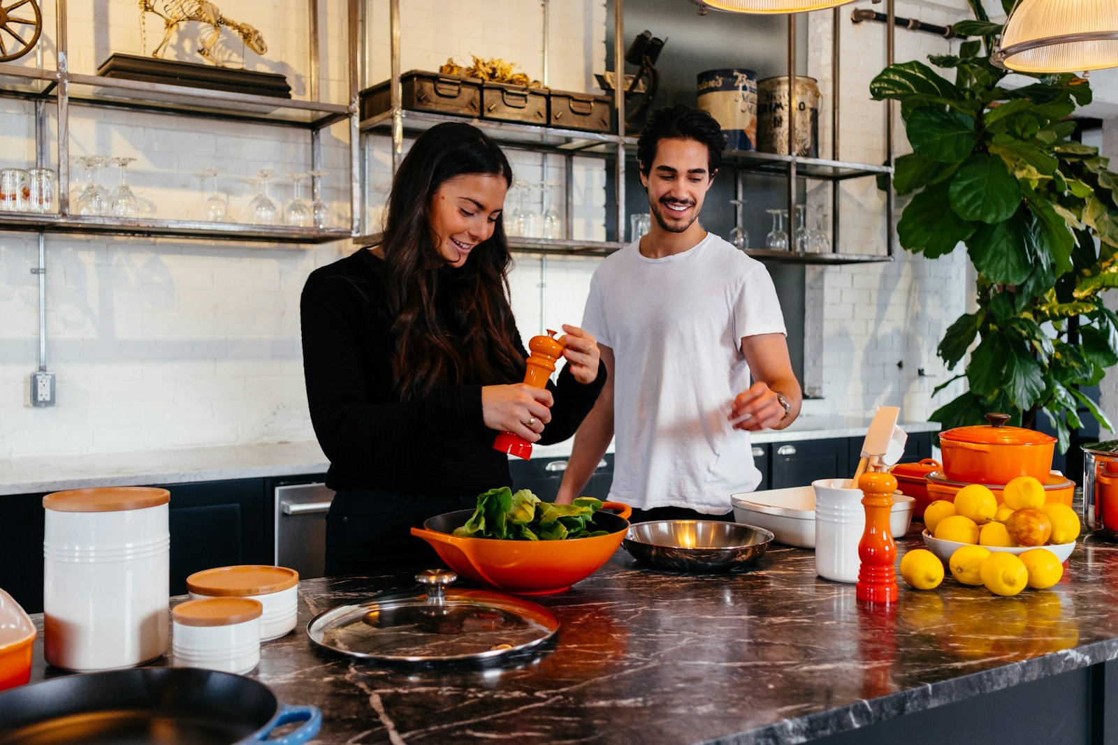 Couple cooking together in a bright kitchen