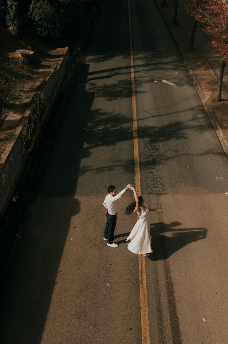 Couple dancing together on an empty street at night