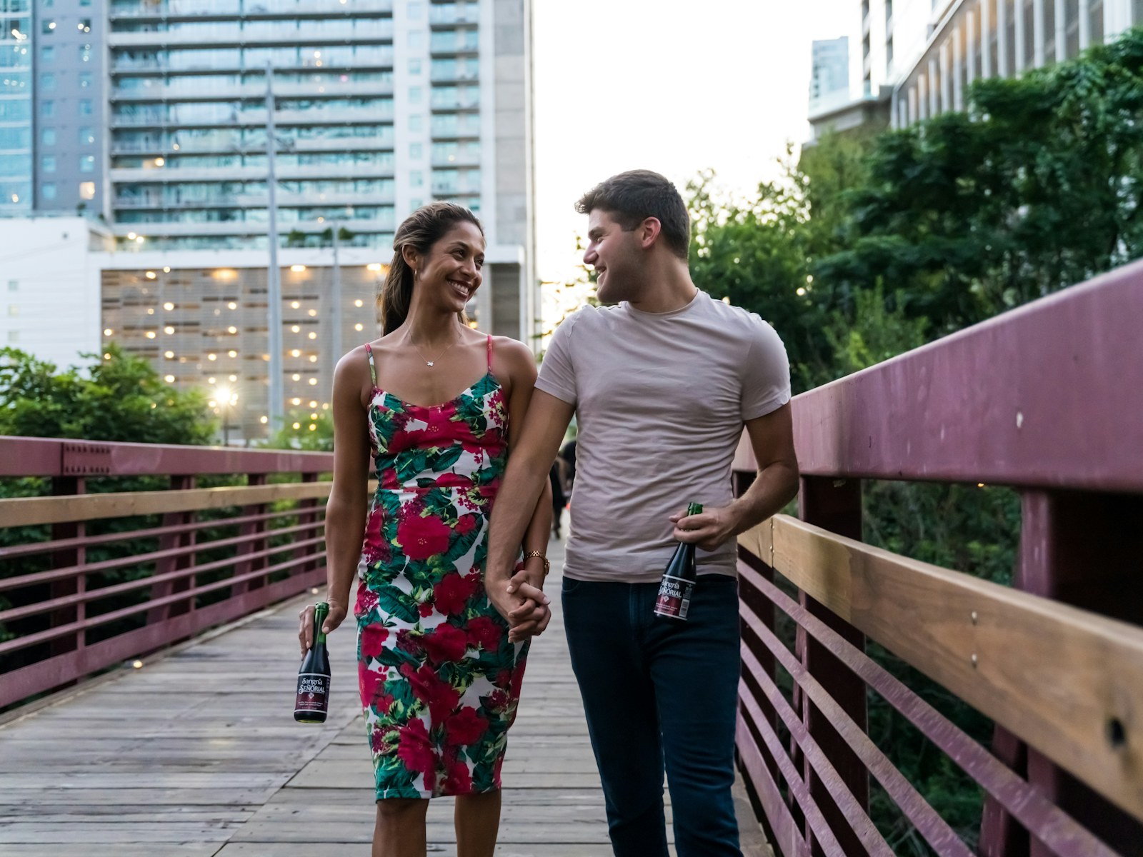 Couple walking together across a city bridge on an ordinary afternoon