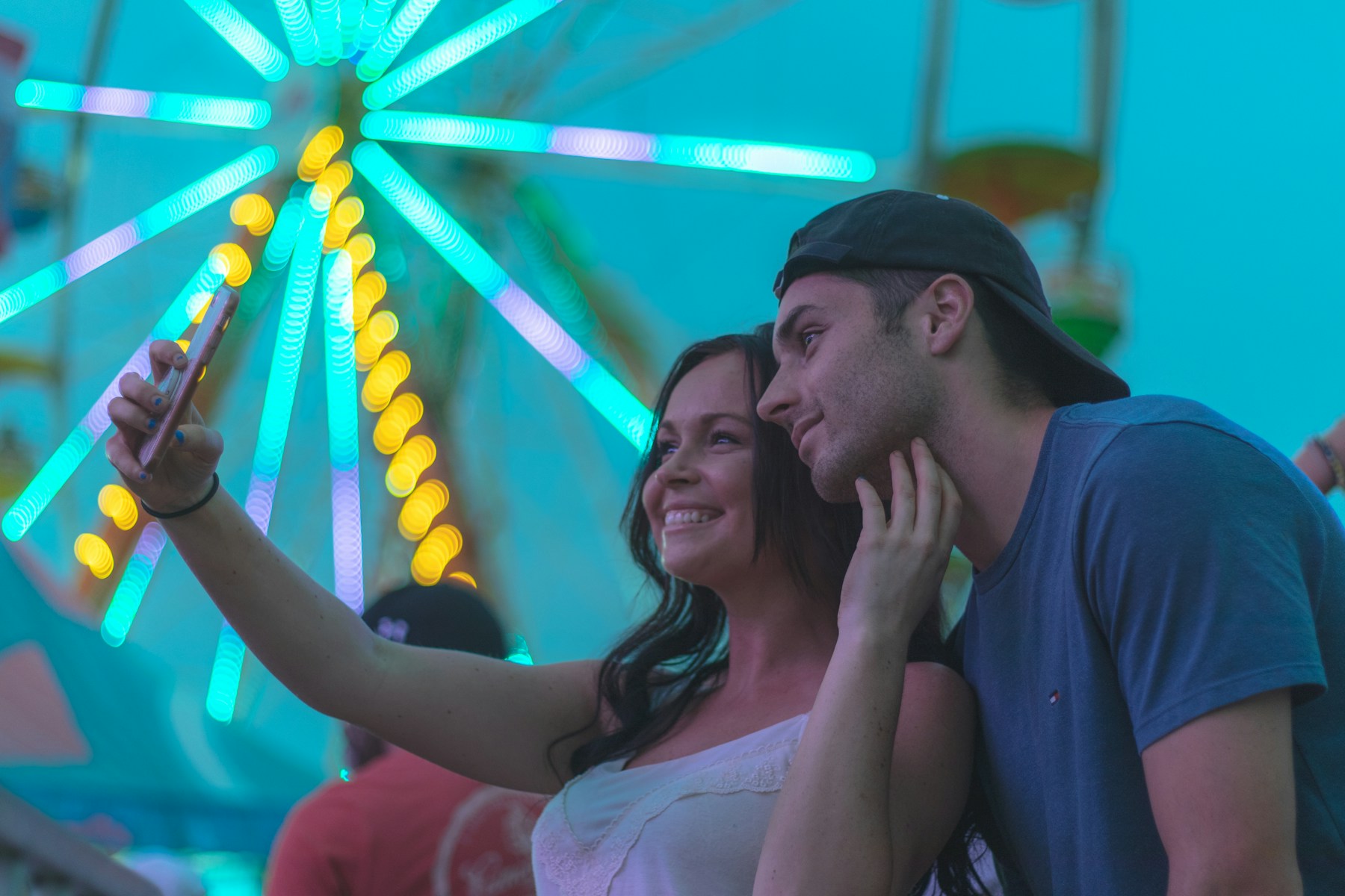 Couple taking a selfie together at a carnival