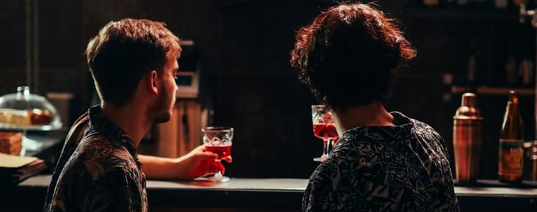 Couple sharing drinks at a cozy bar