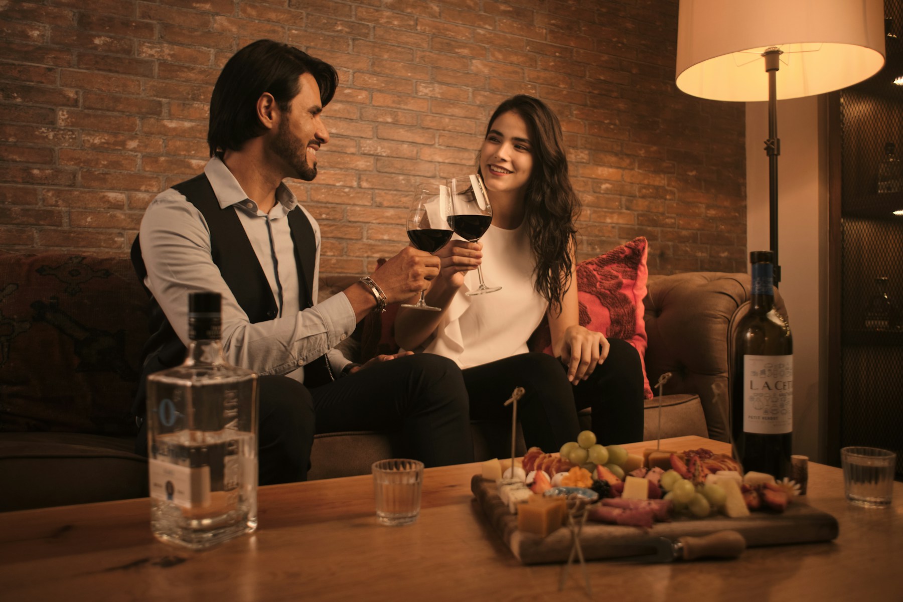 Couple sharing wine on a cozy date night